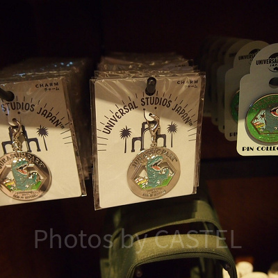 ジュラシックパークのチャーム（左）とピンバッジ（右）
