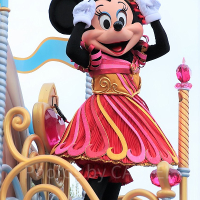 「私とおそろいのカチューシャね」とジェスチャーするミニー